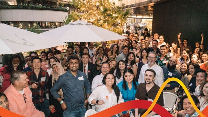 Avanade team — evening group photo with brand graphic