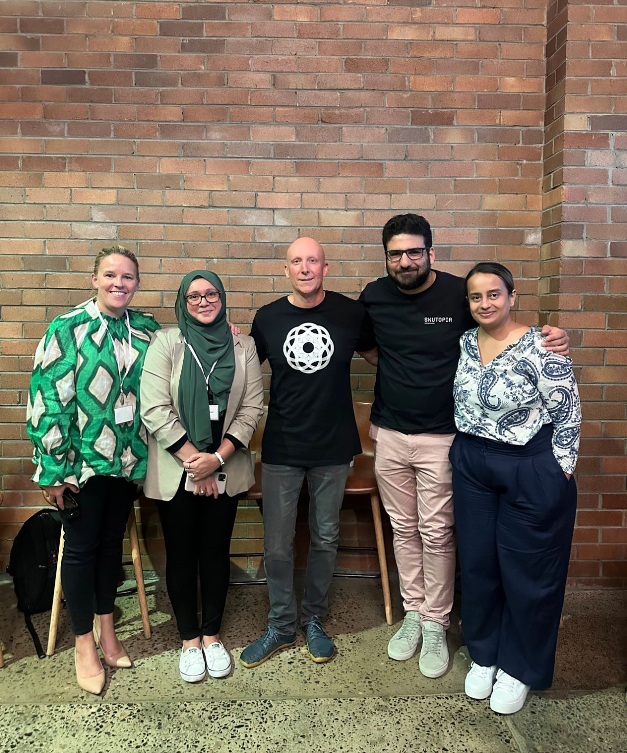 Panel speakers and colleagues posing together at an industry networking evening.